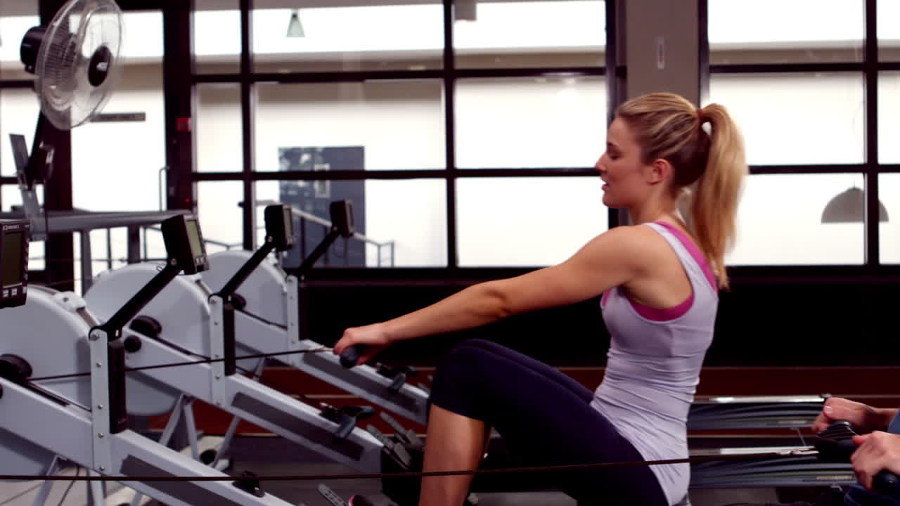Fit people using rowing machine