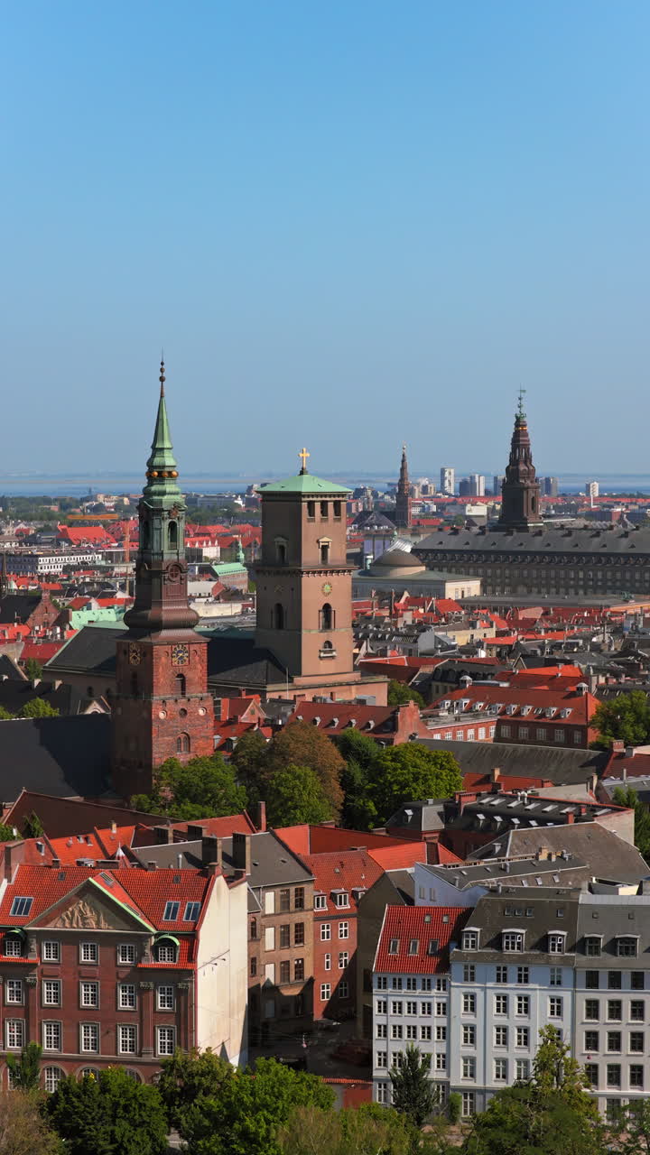 Aerial drone view of St. Peter's Church and Copenhagen skyline at sunrise, Denmark. Vertical