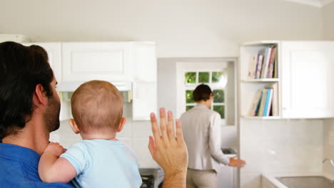 -Family-waving-goodbye-to-businesswoman