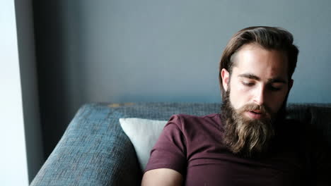 man using laptop on sofa 4k