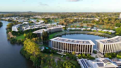 modern buildings surrounded by lush greenery and water