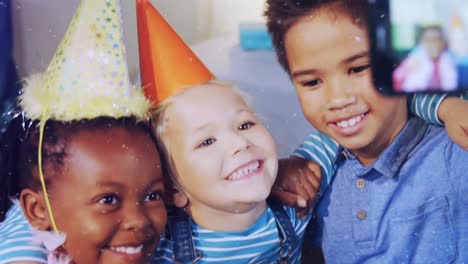 animation of snow falling over diverse children with party hats at birthday party