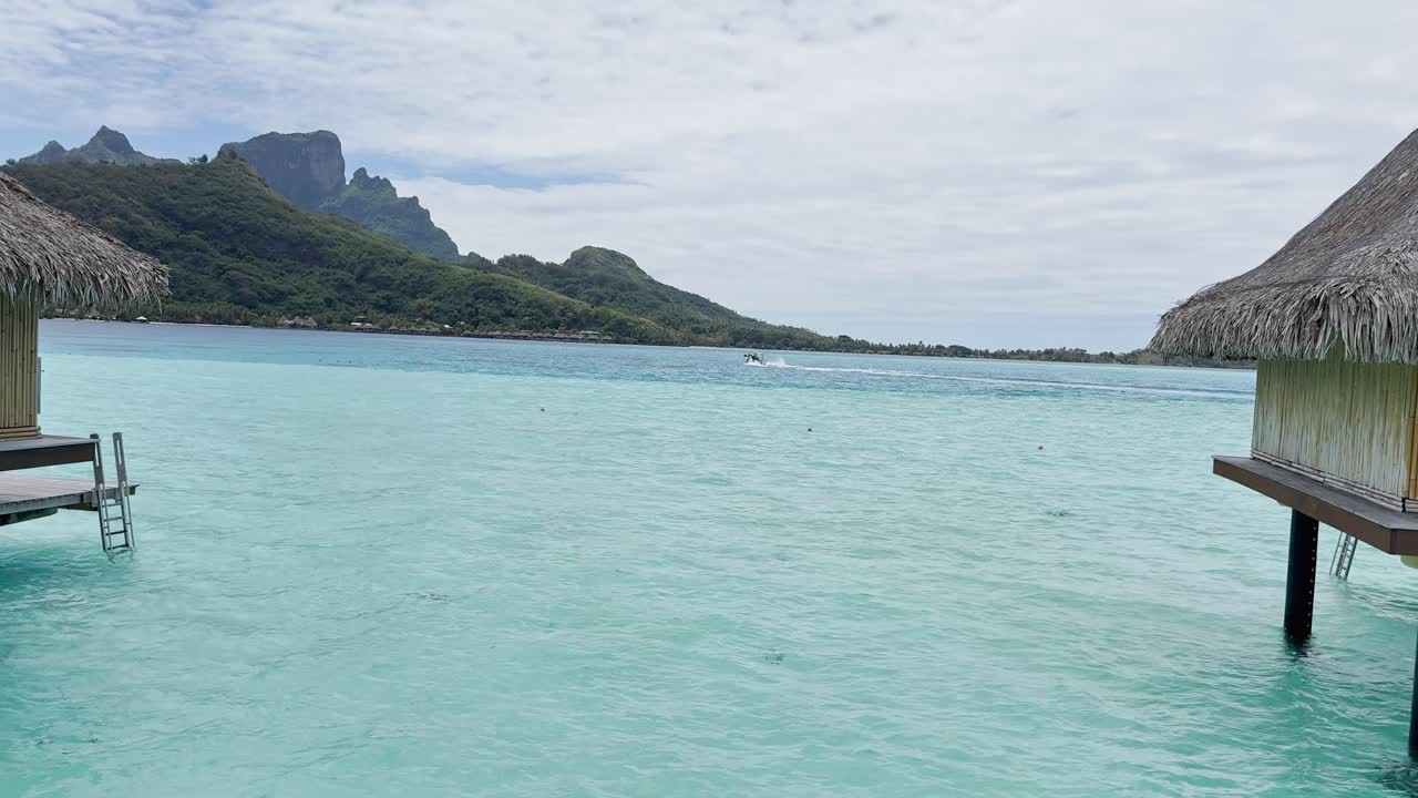 Summer Bora Bora Vacation Resort in French Polynesia with turquoise and aquamarine shallow lagoon clear water