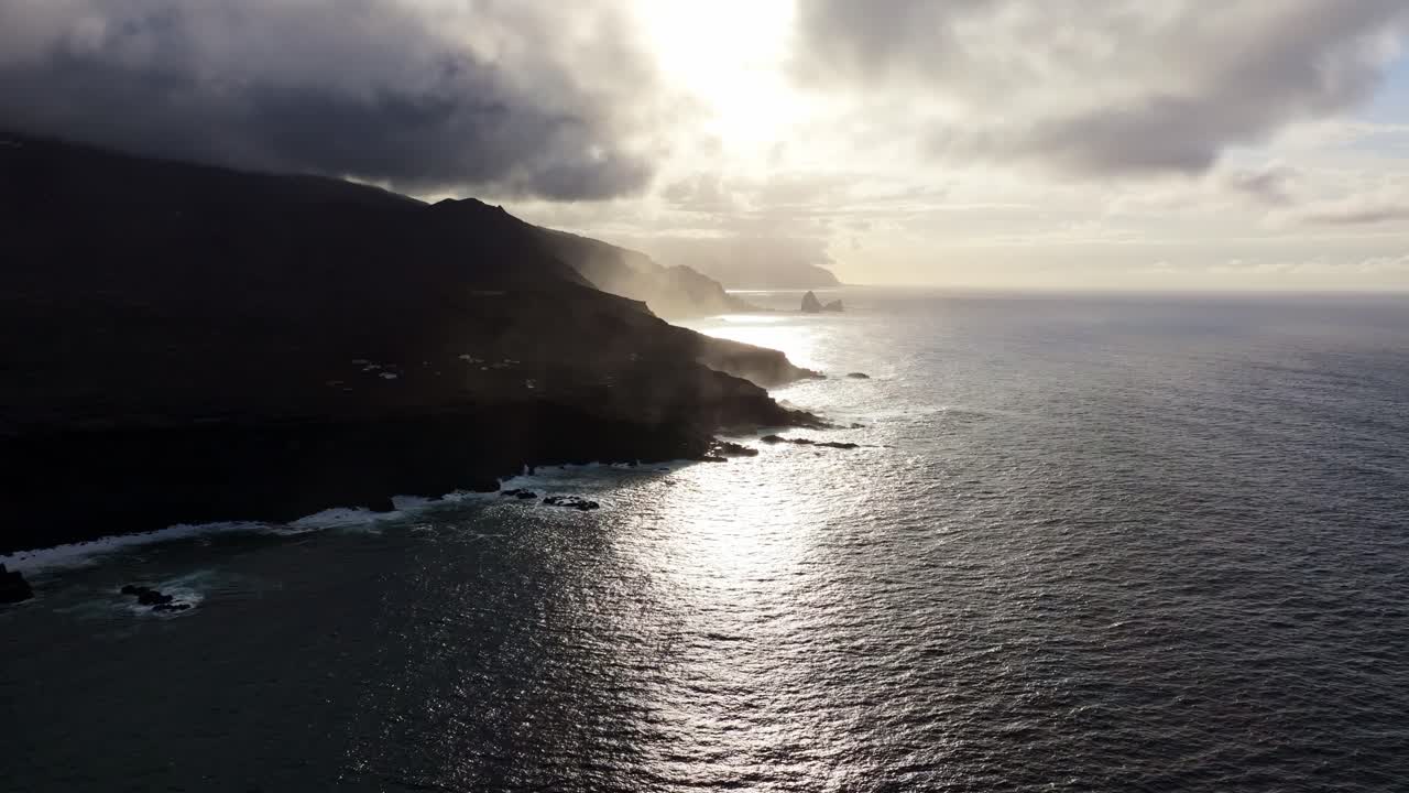 Dramatic sky meets crashing waves along El Hierro cliffs in atmospheric ocean
