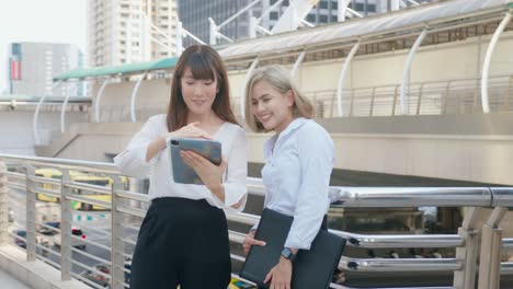happy smiling young business women are working in modern city, talking about business plan
