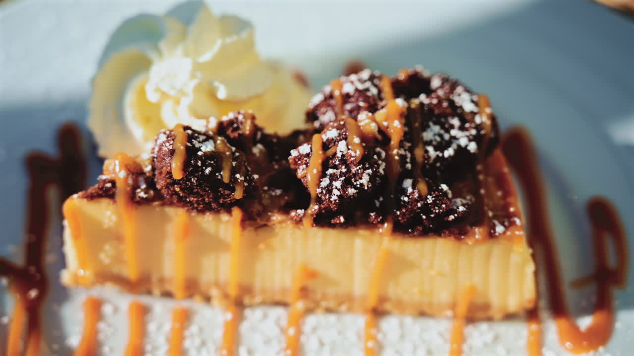 Elegant dessert plated with caramel drizzle, brownie chunks, and whipped cream in a restaurant setting