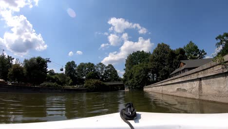 timelapse video of a motorboat sailing through the lake in a leisure park look from inside the boat