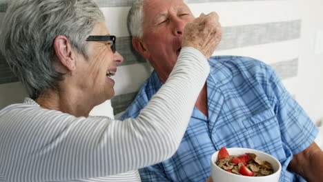 Old-couple-having-breakfast-in-bed