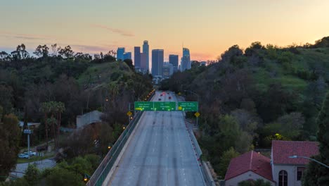 timelapse of traffic on the highway with downtown los angeles skyline from dusk to night