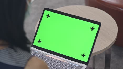 close-up woman using chroma key screen laptop computer