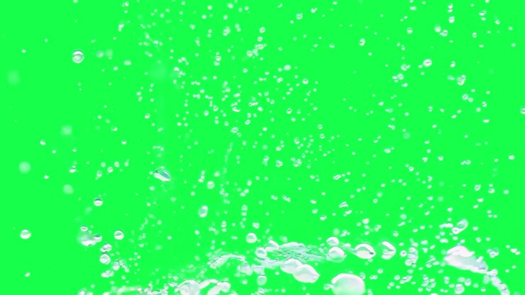 Water Droplets Splashing Against a Green Screen Background