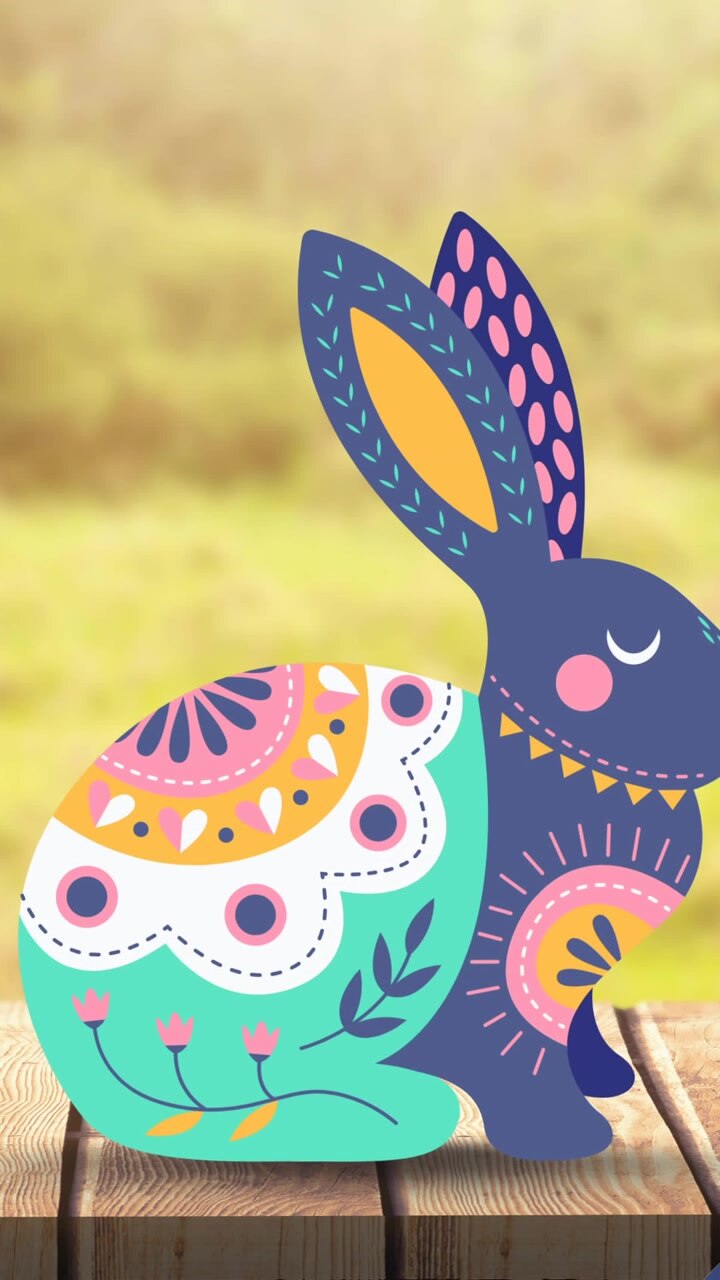 Animation of easter bunny and easter eggs over wooden surface and grass