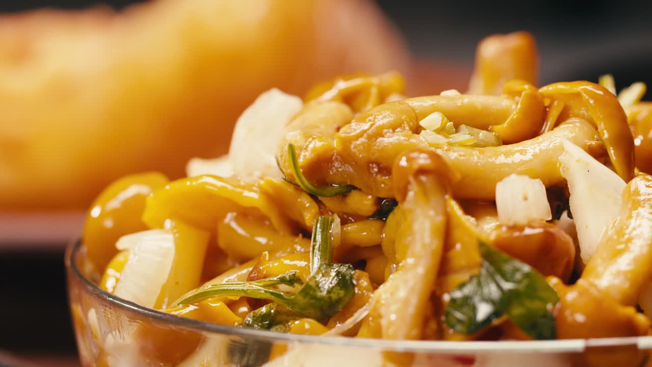 Close-up of fermented yellow honeydew mushrooms with onion in plate. Preservation of vegetables in glass jars. Fermentation preserved mushroom with spices.