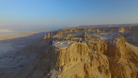 aeriall pull back from masada with the dead sea in the background