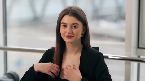 Portrait-of-a-beautiful-young-girl-in-a-business-suit-smiling-at-the-camera