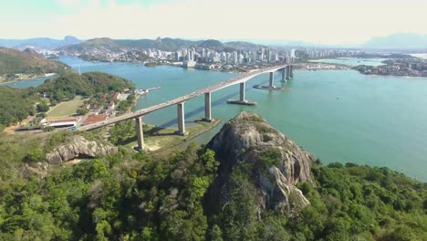Aerial-image-of-the-city-of-Vitória-in-Espirito-Santo,-Brazil,-showing-the-Marca-da-Bahia-and-the-bridge-that-connects-the-two-cities-of-Espírito-Santo
