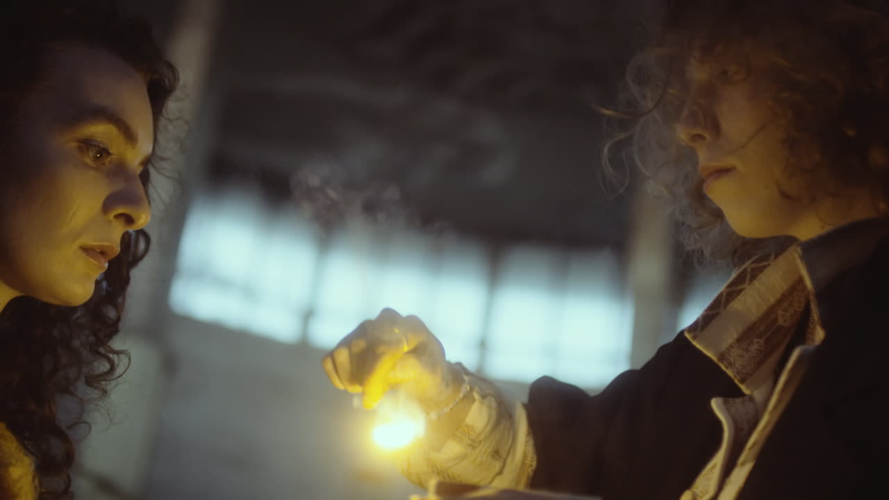 Two individuals interacting with a mysterious glowing object