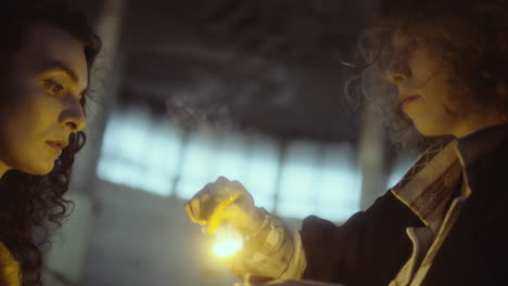 two individuals interacting with a mysterious glowing object