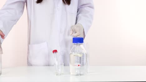 scientist handling bottles for a science experiment