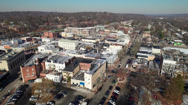 Long aerial reverse shot of downtown Ridgewood, New Jersey, small suburban town, 4K drone footage