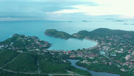Aerial-panoramic-view-of-Ferradura-beach,-scenic-turquoise-Horseshoe-shape-water-bay-in-Buzios