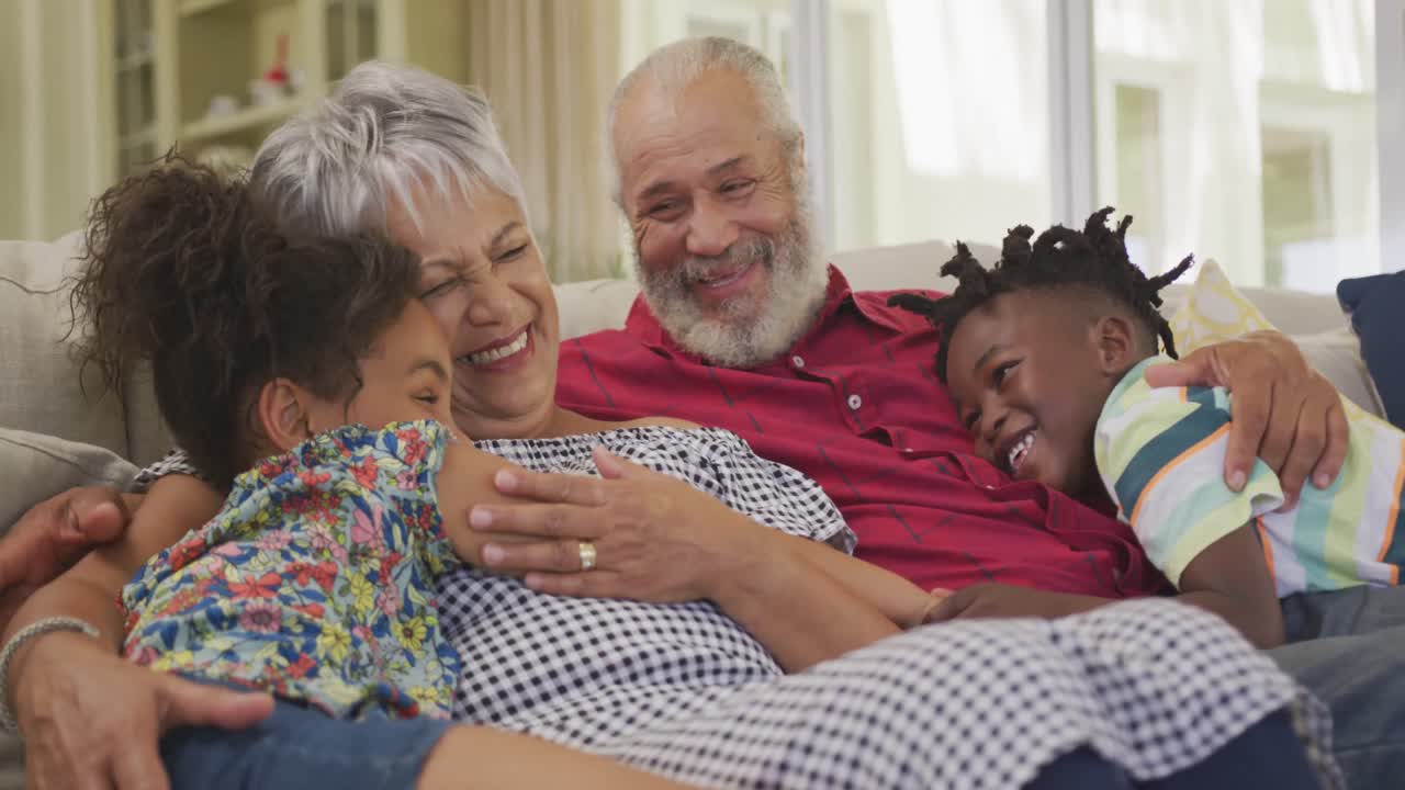 Grandparents embracing their grandchildren at home