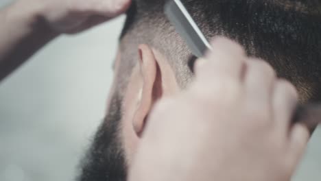 barber haircut with straight razor. barber shaving beard outside