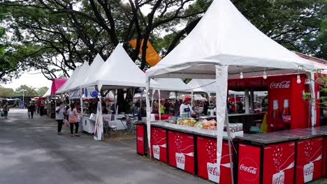 customers browsing at vibrant outdoor market booths.