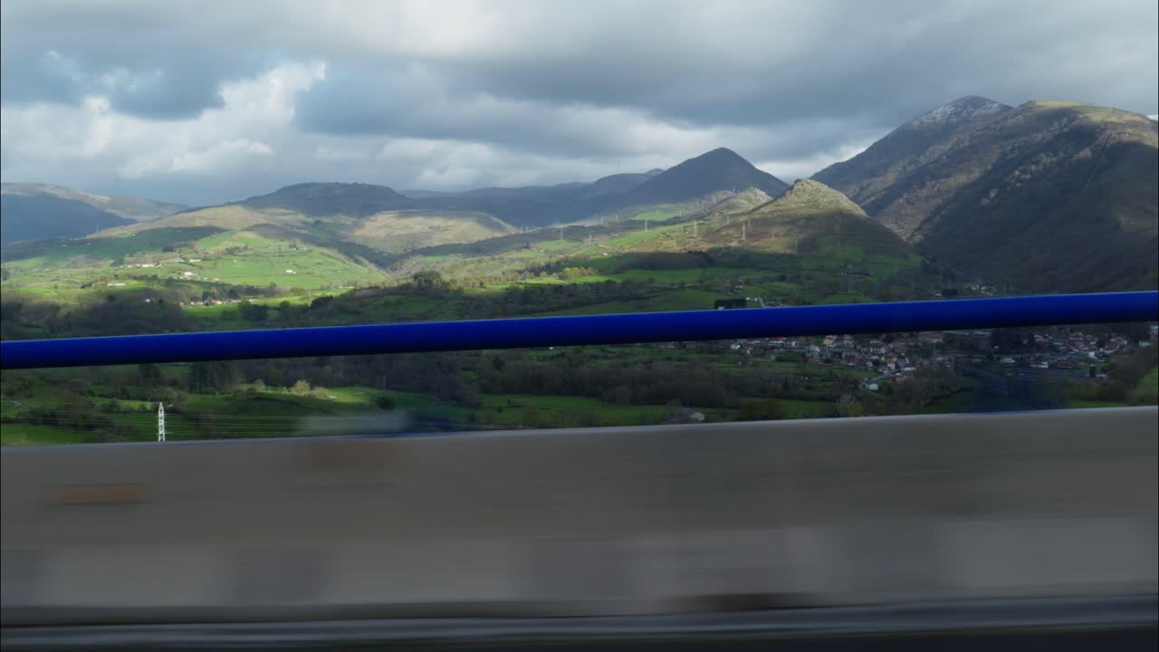 View of Green Mountains and Valleys from a Moving Vehicle