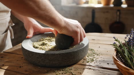 hands grinding dried herbs in a mortar and pestle