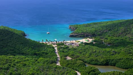 cloud shadows pass over tropical forest by santa cruz beach, caribbean island of curacao