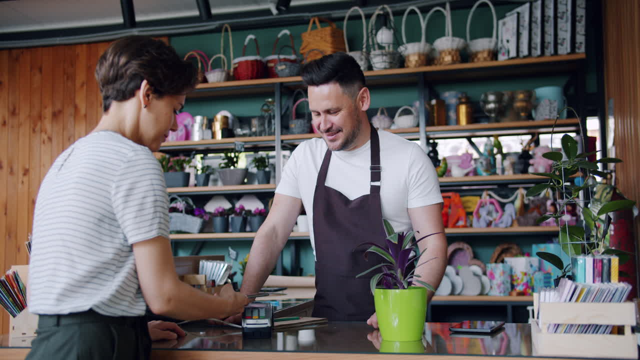 Customer Paying for Plants in a Florist Shop