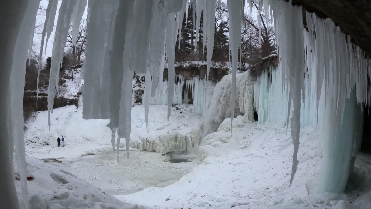 Winter landscape with a frozen waterfall and large icicles