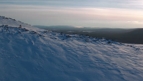 Stunning-cinematic-close-proximity-aerial-shot-over-a-sunset-mountainside