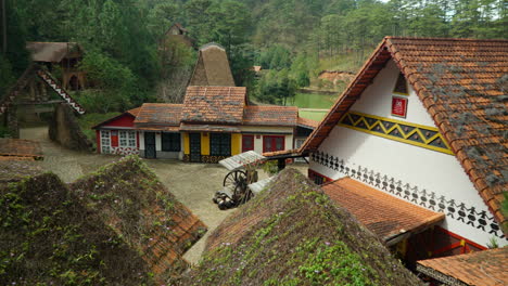 Casas-Antiguas-En-La-Aldea-Popular-De-Cu-Lan,-Vietnam---Tejas-Naranjas-Cubiertas-De-Plantas-Sinuosas-Y-Musgo