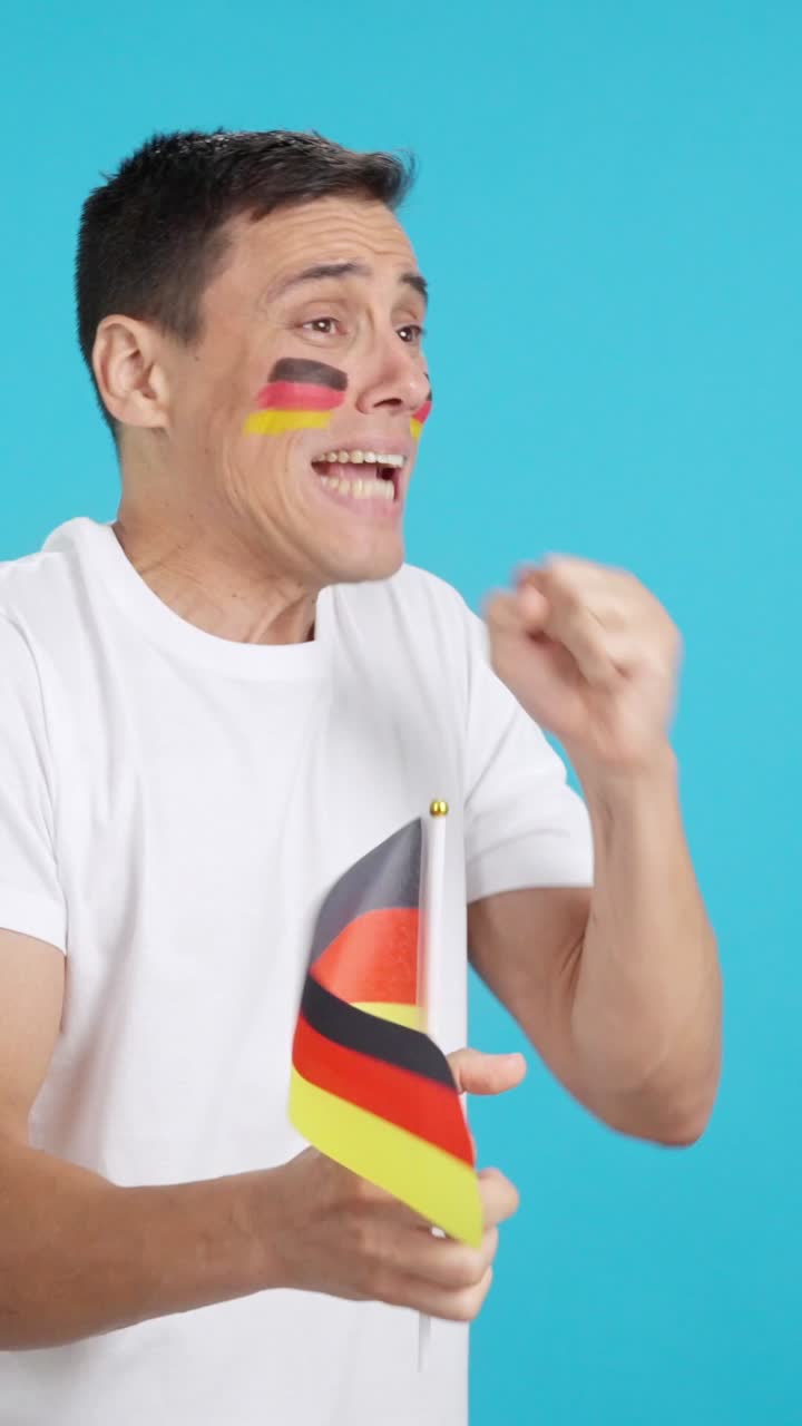 Nervous german supporter during an exciting match looking away