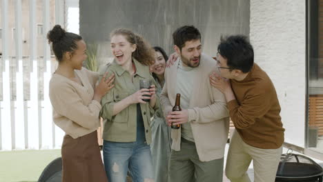 a nice  group of friends chatting happily on a terrace of a house