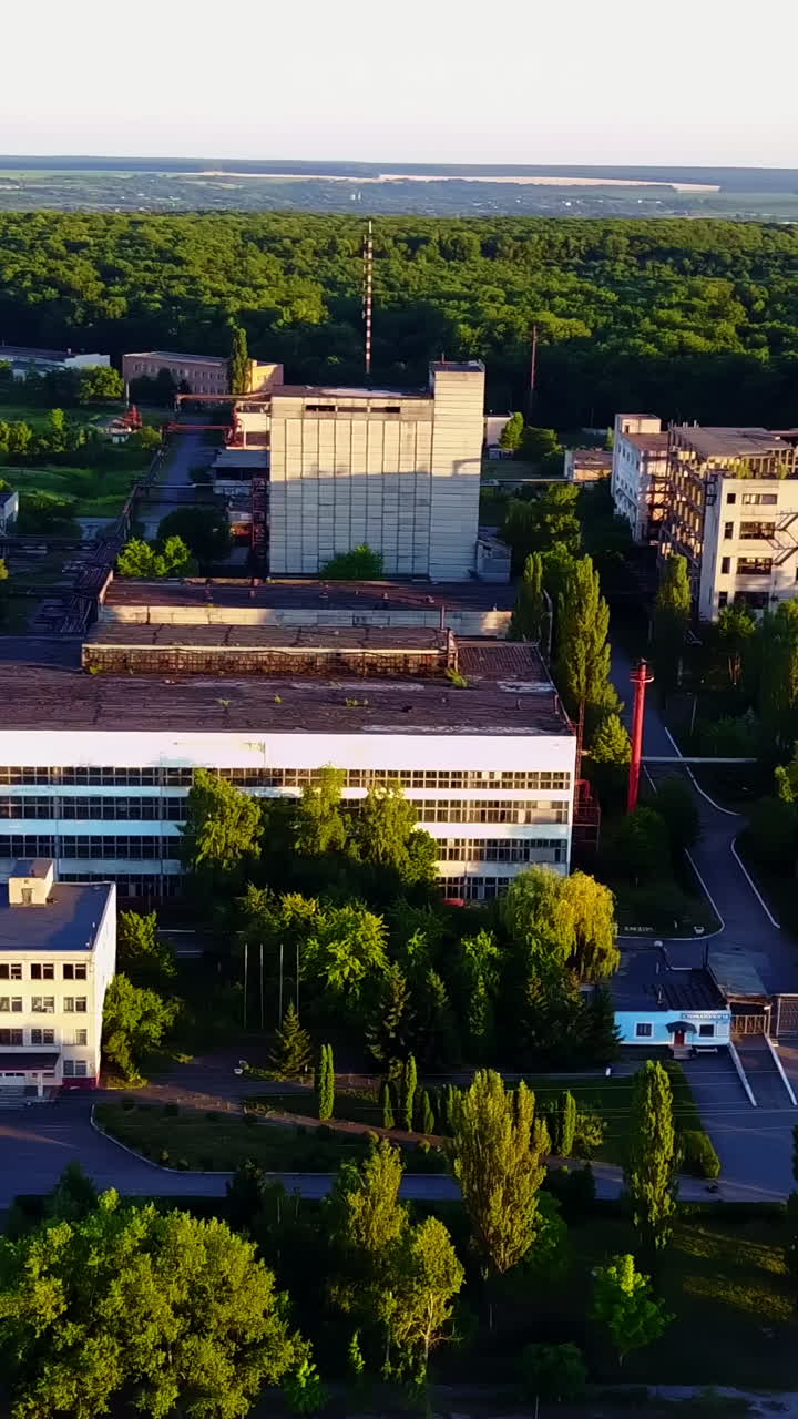 Abandoned Old Buildings. Aerial view of the ruins of an old abandoned factory near farmland Vertical video