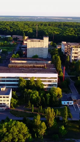 abandoned old buildings. aerial view of the ruins of an old abandoned factory near farmland vertical video