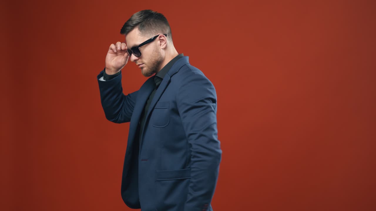 Portrait of businessman on background. Handsome young man in suit looking at camera while standing against background