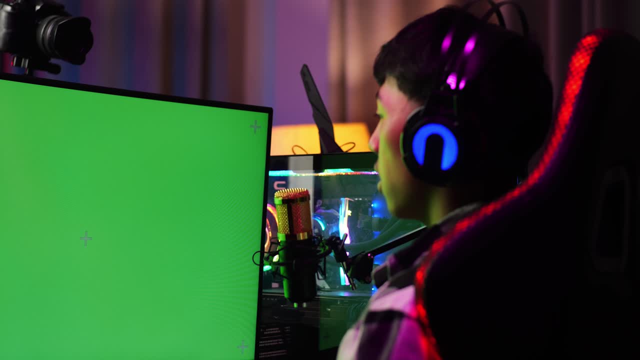 Close Up Back View Of Asian Boy Streamer Screaming Goal And Dancing Celebrating Winning Game On Green Screen Computer.  Live Stream Video Game, Desk Illuminated By Rgb Led Strip Light