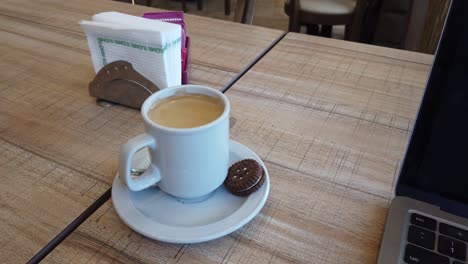 close-up view of italian espresso and chocolate cookie on a cozy table setting