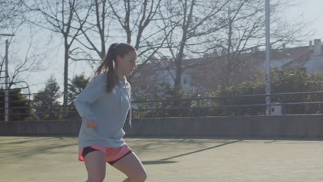 Three-Teenaged-Girls-Playing-Soccer-Outdoors-On-Sunny-Day