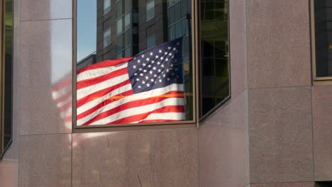 Reflection-of-USA-Flag-Flying-in-a-Window