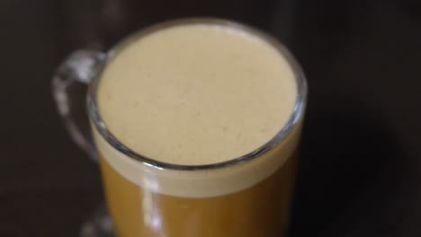 rack focus on a cup of keto-friendly bulletproof coffee