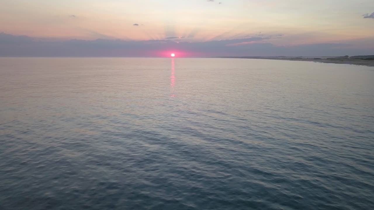 Aerial view over the sea with the sunset, the sun was orange, Rocha, La paloma, Uruguay