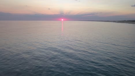 aerial view over the sea with the sunset, the sun was orange, rocha, la paloma, uruguay