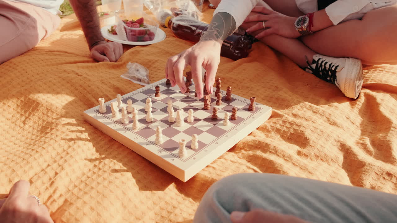 Friends Playing Chess at a Picnic