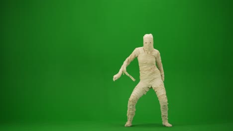 a mummy wrapped in bandages dancing oriental dance moving gracefully green screen isolated chroma
