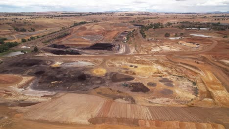 Open-pit-coal-mine-aerial-lowering-pan-up